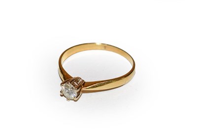 Lot 211 - A diamond solitaire ring, the round brilliant cut diamond in a white claw setting, to a yellow...