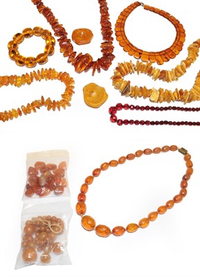 Lot 228 - Three irregular shaped amber bead necklaces, various lengths, three amber type necklaces, an...