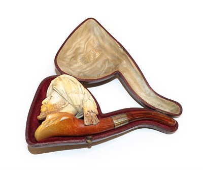 Lot 246 - A Meerschaum pipe carved as a Turks head with amber mouthpiece and silver collar, cased
