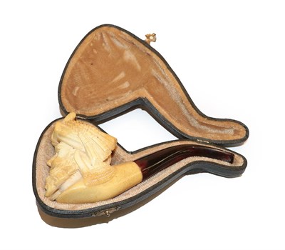 Lot 247 - A Meerschaum pipe carved as a Turks head with amber mouthpiece, cased