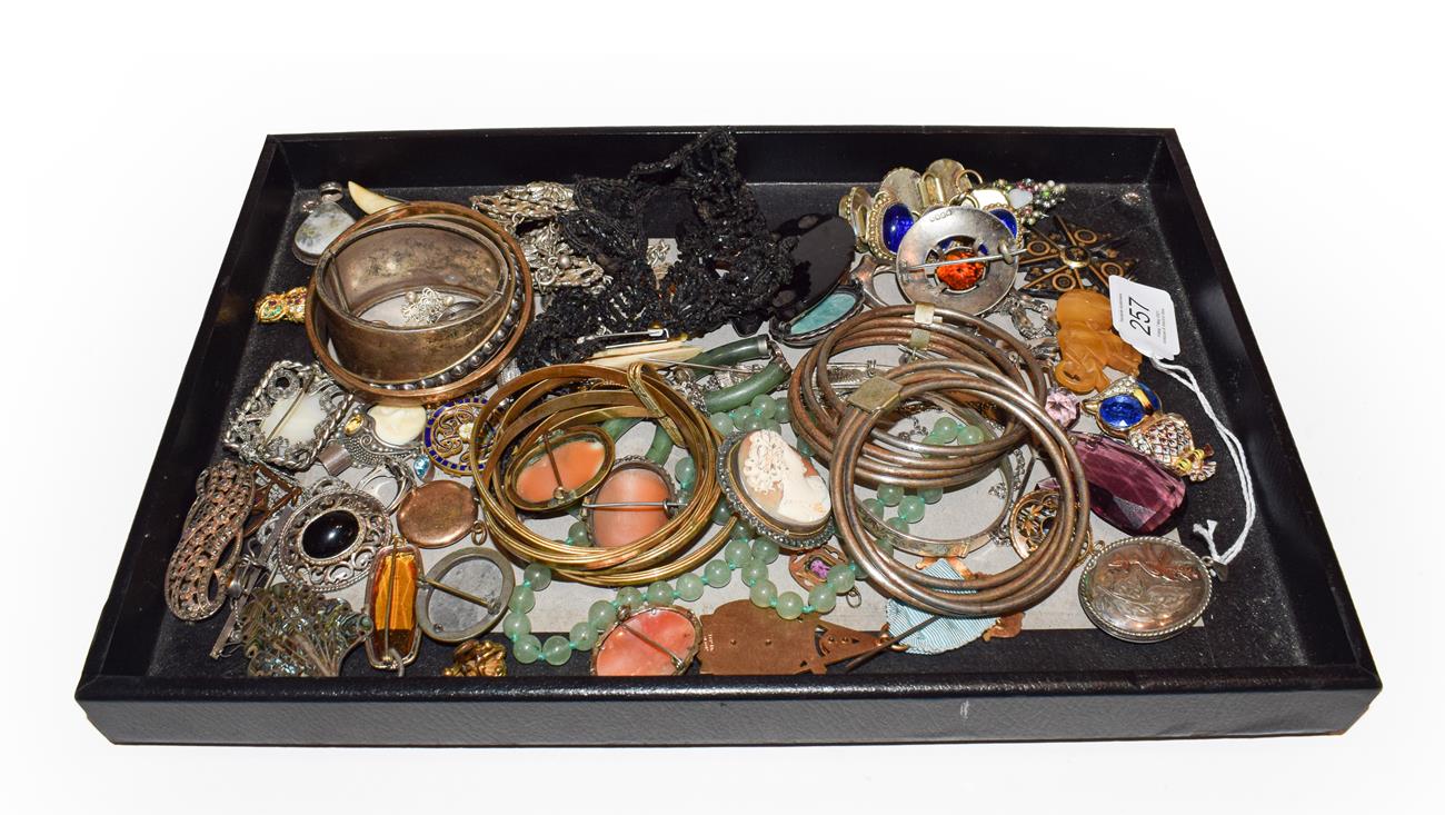 Lot 257 - A quantity of costume jewellery including bangles, brooches, pendants, lockets, rings, a bead...