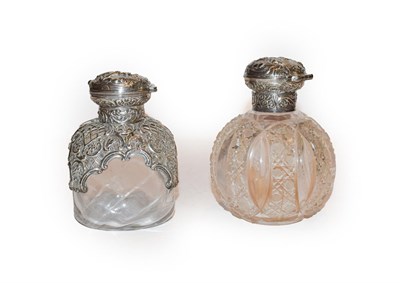 Lot 287 - Two silver mounted glass scent bottles, by William Comyns, London, 1895, one globular, one of...