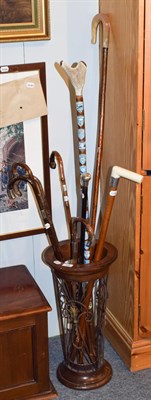 Lot 328 - A collection of walking sticks in modern stand including an example with silver pommel and...