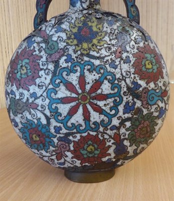 Lot 335 - A 19th century Chinese cloisonne moon flask, twin handled and decorated with stylized flowers...