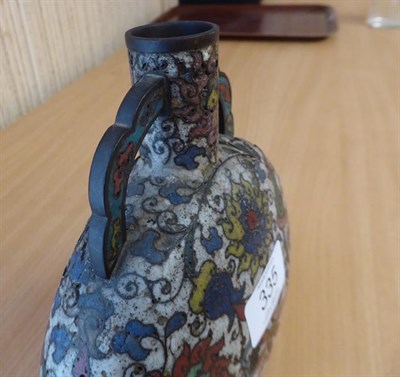 Lot 335 - A 19th century Chinese cloisonne moon flask, twin handled and decorated with stylized flowers...
