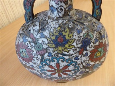 Lot 335 - A 19th century Chinese cloisonne moon flask, twin handled and decorated with stylized flowers...