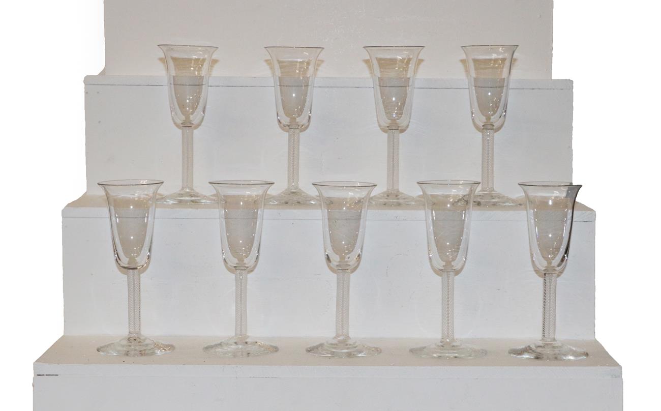 Lot 360 - A set of nine 20th century air twist glasses with bell formed bowls and domed feet