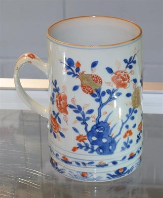 Lot 362 - An 18th century Chinese Imari tankard, with reeded strap handle and painted with flowering...