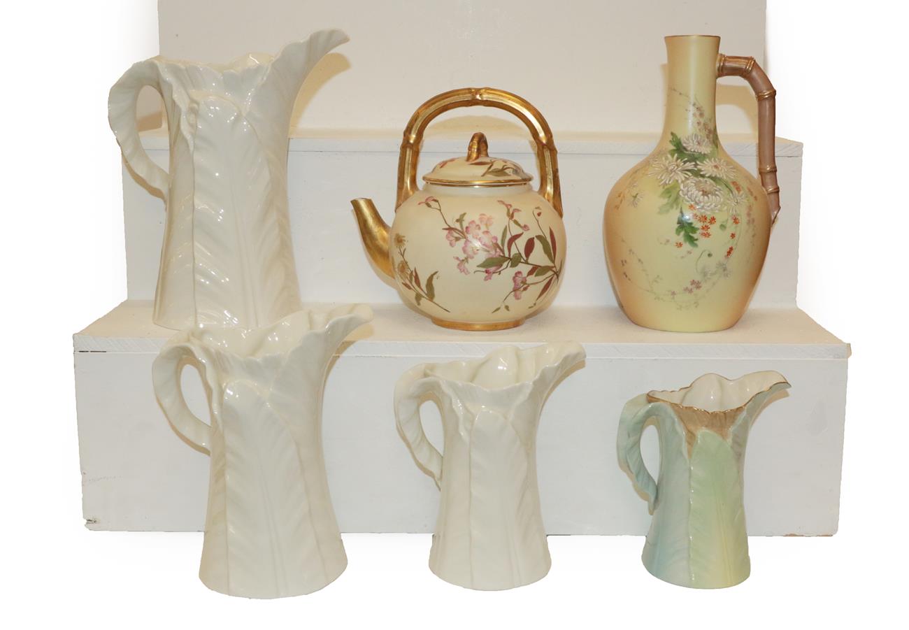 Lot 371 - A Royal Worcester blush ground aesthetic movement kettle, a similar ewer and four palm leaf moulded