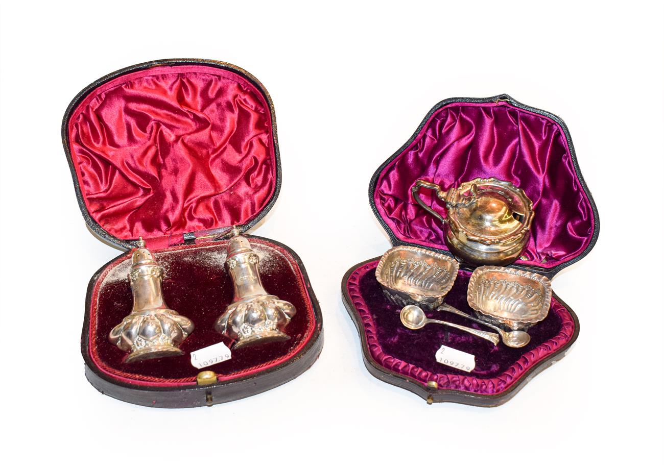 Lot 381 - Pair of silver pepperettes, a pair of silver salts with spoons, both cased and a silver mustard pot