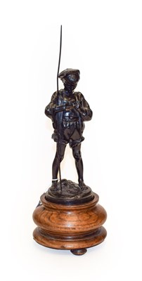 Lot 402 - A Russian patinated cast iron figure of a fisher boy, on an oak pedestal