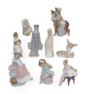 Lot 427 - A collection of Lladro figures including a seated ballerina, Inuit girl with a polar bear cub and a