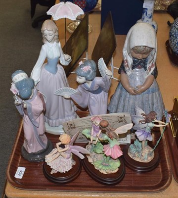 Lot 439 - Four Lladro figures including a large example formed as a Spanish girl wearing a head scarf...