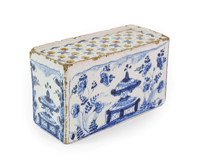 Lot 22 - An English Delft Flower Brick, circa 1740, of rectangular form, painted in blue with pagodas...