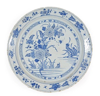 Lot 24 - An English Delft Charger, possibly Liverpool, circa 1750, painted in blue with peony within a...