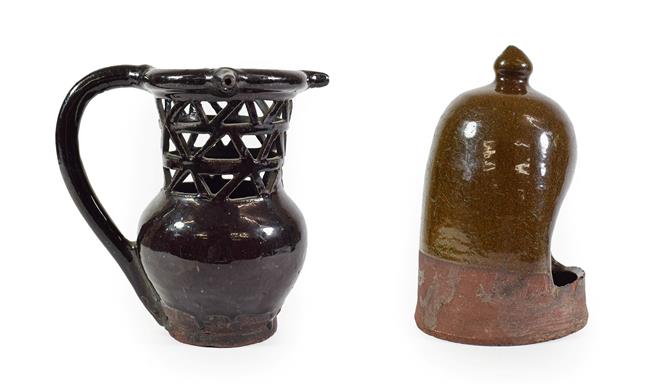 Lot 38 - A Black Glazed Puzzle Jug, 19th century, of traditional form with triple spouts and pierced neck on