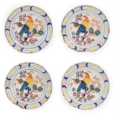 Lot 60 - A Set of Four Delft Pancake Plates, circa 1740, painted in colours with a parrot perched in a...