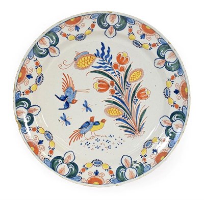 Lot 65 - A Dutch Delft Charger, circa 1730, painted in enamels with birds amongst foliage within foliate...