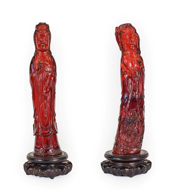 Lot 93 - A Matched Pair of Chinese Pressed Amber Figures, late 19th/20th century, each modelled as...