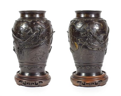 Lot 99 - A Pair of Japanese Bronze Vases, Meiji period, of baluster form, cast with dragons and birds flying