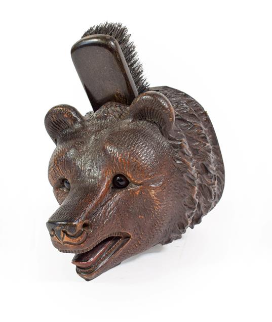 Lot 126 - A Black Forest-Type Carved Brush Holder, early 20th century, naturalistically carved as the head of