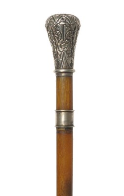 Lot 1257 - A Rhinoceros Horn Walking Stick, late 19th century, with white metal bulbous pommel repoussé...