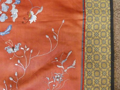 Lot 304 - A Chinese Silk Embroidered Panel, 20th century, the peach ground worked with flowers and birds...