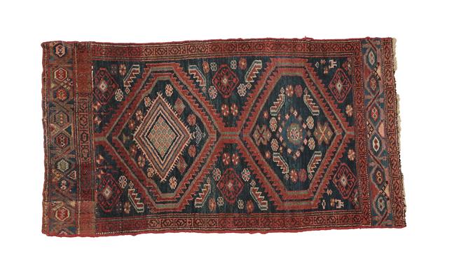 Lot 322 - Kurdish Rug West Iran, circa 1920 The indigo field with two serrated medallions enclosed by...