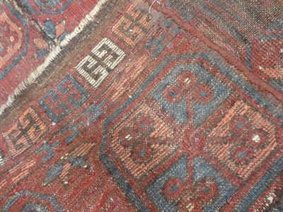 Lot 330 - Afghan Baluch Rug, circa 1900 The field with two octagonal güls enclosed by narrow borders,...