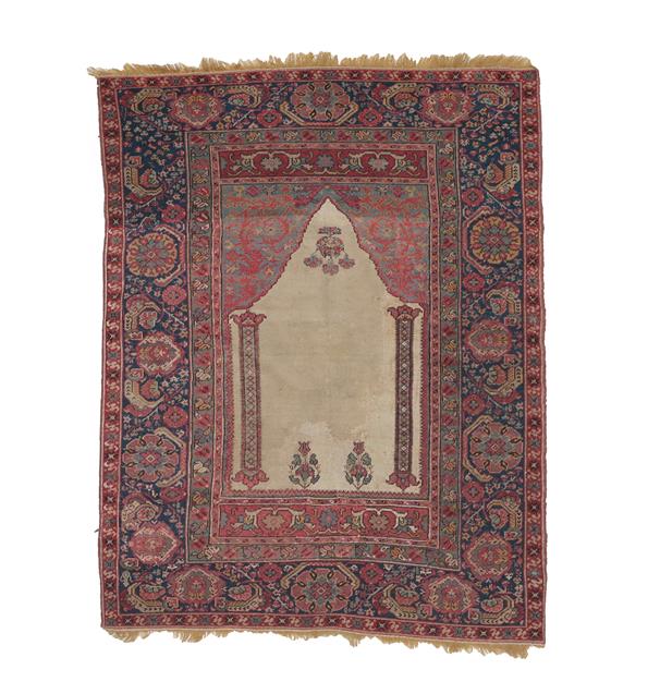 Lot 351 - Giordes Prayer Rug Central Anatolia, probably 18th century The plain ivory field with two...
