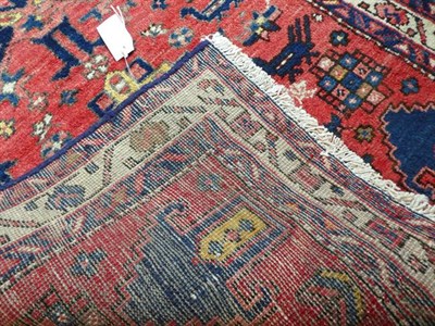 Lot 353 - Narrow Heriz Runner North West Iran, circa 1940 The soft tomato red field with a one way design...