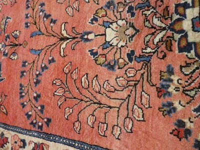 Lot 366 - Saroukh Runner  West Iran, circa 1960 The coral pink field with a column of flowering plants...