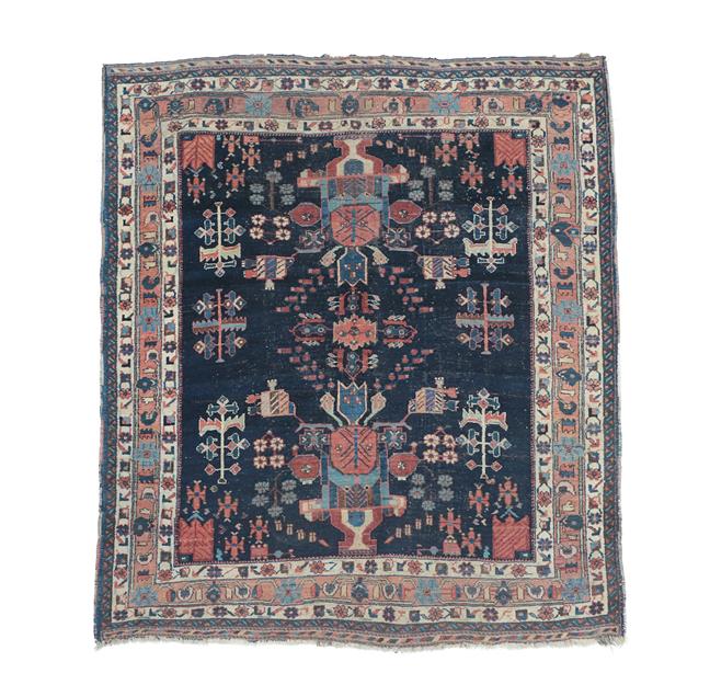 Lot 369 - Afshar Rug South East Iran, circa 1920 The indigo field with two urns issuing flowers enclosed...
