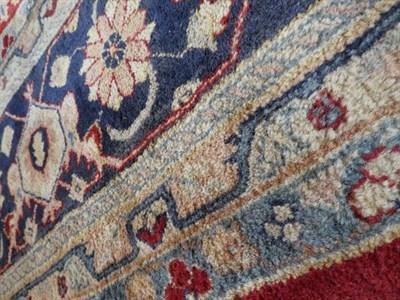 Lot 379 - Large Indian Carpet, modern The brick red field with an allover design of flowing vines and...