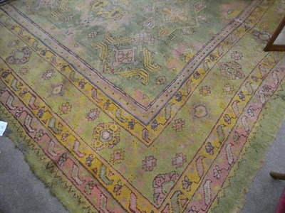Lot 381 - Ushak Carpet Central/West Anatolia, circa 1900 The faded olive green field with columns of...
