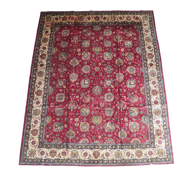 Lot 383 - Tabriz Carpet Iranian Azerbaijan, circa 1950 The deep raspberry field with an allover design of...