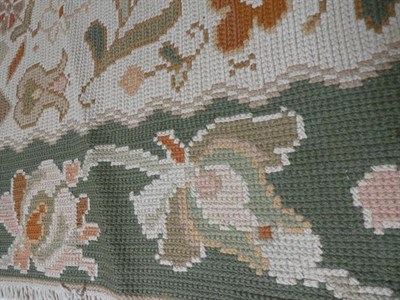 Lot 387 - Portuguese Flatweave Carpet, 2nd half 20th century The cream field of flowering plants around a...