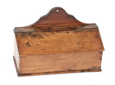 Lot 409 - ~ An Elm Candle Box, 18th century, with shaped arched cresting over a sloping hinged fall and...