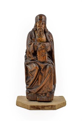 Lot 414 - ~ A Carved Limewood Figure of a Saint, probably South German, 16th century, seated wearing...