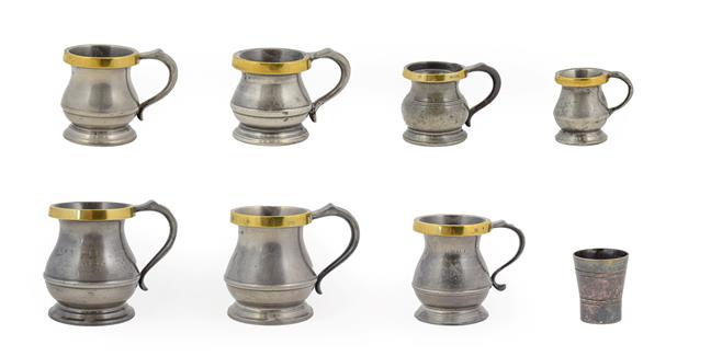 Lot 420 - ~ A Matched Graduated Set of Seven Brass Mounted Pewter Measures, 19th and 20th century, of...
