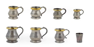 Lot 420 - ~ A Matched Graduated Set of Seven Brass Mounted Pewter Measures, 19th and 20th century, of...
