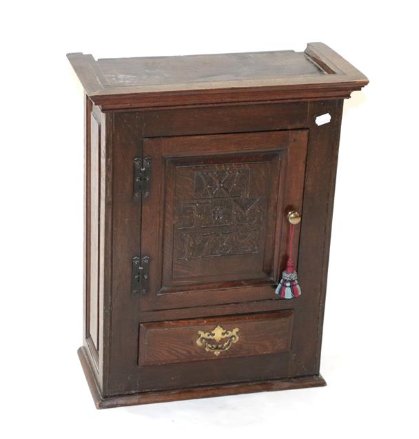 Lot 426 - ~ An 18th Century Joined Oak Wall-Mounted Mural Cupboard, initialled and dated WTM 1733, the...