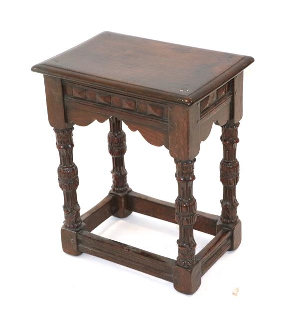 Lot 427 - ~ A Carved Oak Joint Stool, late 19th/early 20th century, labelled Heaton Tabb & Co, Bold...