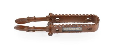 Lot 434 - ~ A Pair of Welsh Treen ''Love Token'' Sugar Tongs, late 19th century, of traditional form, pierced