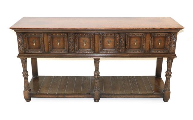 Lot 441 - ~ An Early 20th Century Oak Dresser Base, in 17th century style, the moulded top above three...