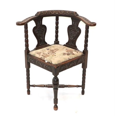 Lot 443 - ~ A Victorian Carved Oak Corner Elbow Chair, mid 19th century, the guilloche carved top rail...