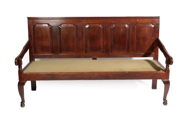 Lot 456 - A George III Joined Oak Settle, late 18th century, the moulded top rail above five fielded...