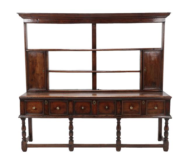 Lot 457 - An Early 18th Century Open Dresser and Rack, with three fixed shelves above two cupboard doors, the