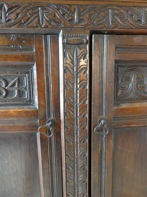 Lot 460 - A 17th Century Joined Oak Livery Cupboard, initialled and dated SLM 1684, the later top above a...