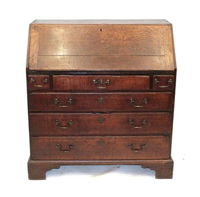 Lot 461 - An Early 18th Century Oak and Pine-Lined Bureau, the fall front enclosing a simple interior of...